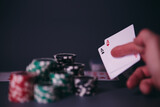 Dealer or croupier shuffles poker cards in a casino on the background of a table, chips. Concept of poker game, game business. Playing for money, a big win, a jackpot, gambling, a desire to get rich.	