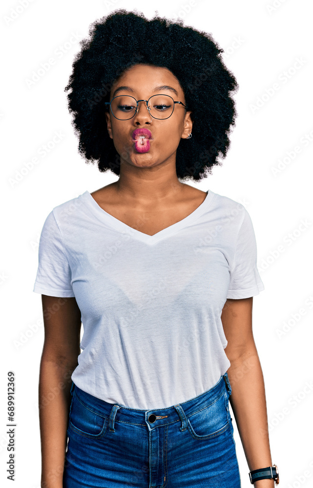 Young african american woman wearing casual white t shirt making fish face with lips, crazy and comical gesture. funny expression. Young african american woman wearing casual white t shirt making fish face with lips, crazy and comical gesture. funny expression.