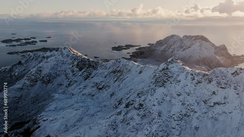 Wallpaper Mural The winter charm of Mount Norway Lofoten, where a snow-covered mountain peak stands against the cold backdrop of clear blue skies. Torontodigital.ca