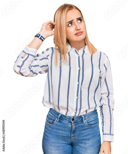 Beautiful caucasian woman wearing casual clothes confuse and wondering about question. uncertain with doubt, thinking with hand on head. pensive concept.