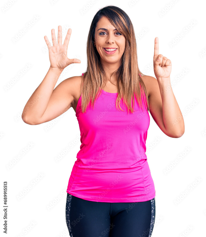 Young beautiful woman wearing sportswear showing and pointing up with fingers number six while smiling confident and happy. Young beautiful woman wearing sportswear showing and pointing up with fingers number six while smiling confident and happy.