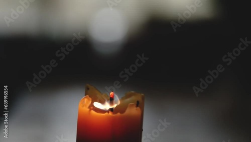 Blowing out a beeswax candle.