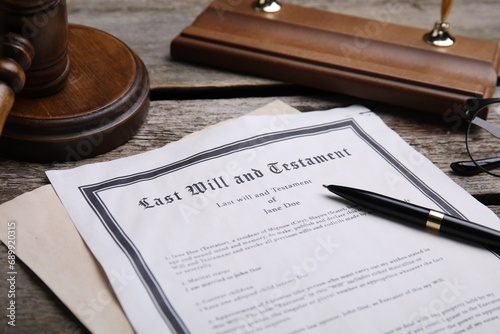 Last will and testament with pen on wooden table photo