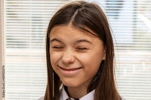 Bilde på lerret Emotional portrait of a teenage girl, grimacing and laughing.