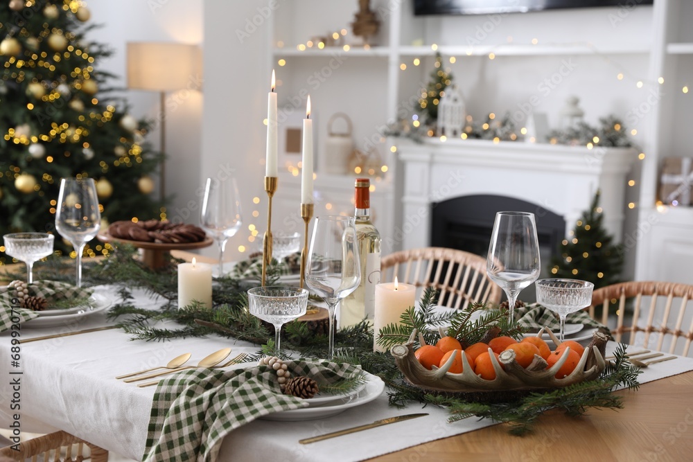 Fototapeta premium Christmas table setting with festive decor and dishware in living room