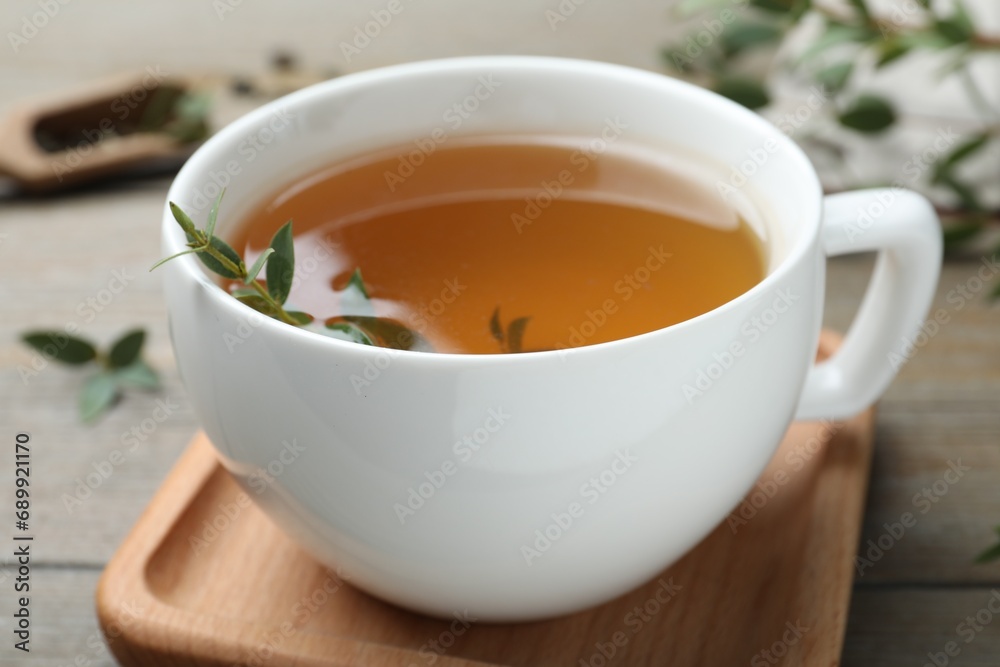 Cup of aromatic eucalyptus tea on wooden table, closeup Cup of aromatic eucalyptus tea on wooden table, closeup