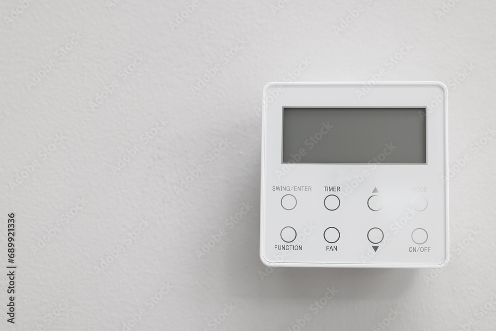 One thermostat on white wall indoors, space for text. Smart home system One thermostat on white wall indoors, space for text. Smart home system