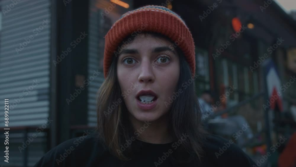 Close up portrait of a hipster girl in the city on the street, blowing bubble gum. A fashionable woman of generation Z. A female millennial chews chewing gum in town. Slow motion Close up portrait of a hipster girl in the city on the street, blowing bubble gum. A fashionable woman of generation Z. A female millennial chews chewing gum in town. Slow motion