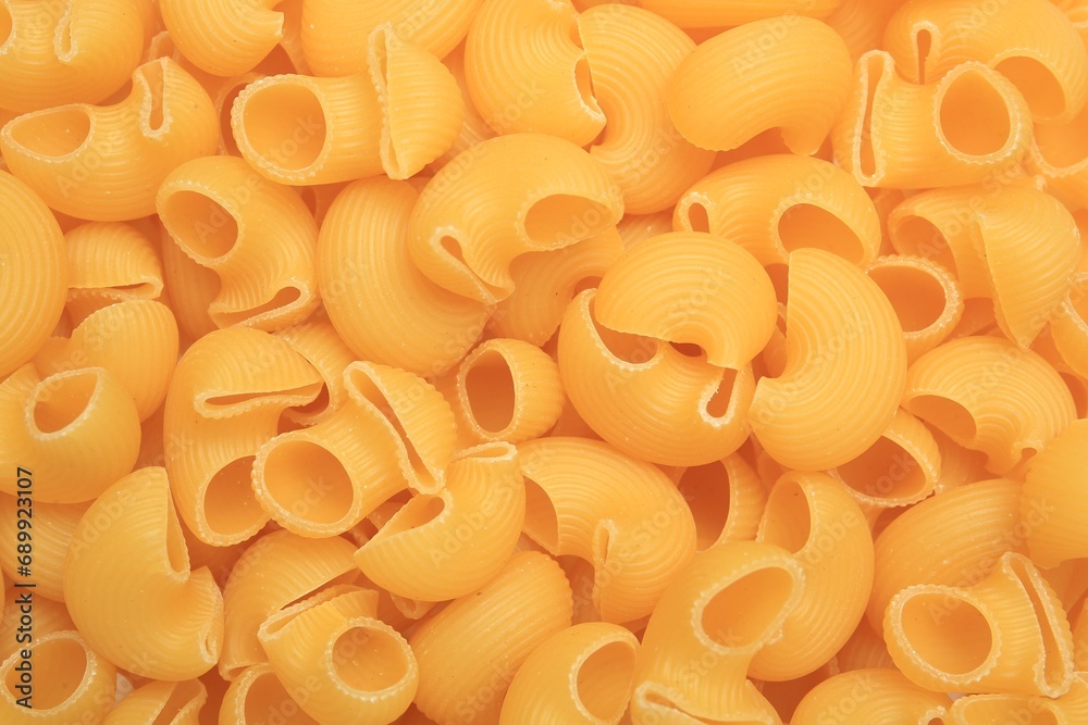 Raw horns pasta as background, top view Raw horns pasta as background, top view