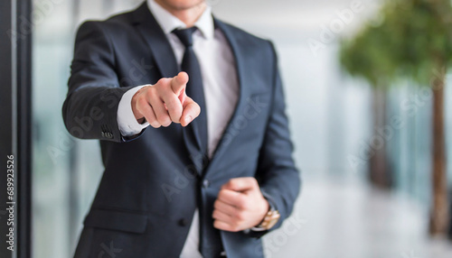 businessman pointing directly at viewer with copy space, conveying authority and direction in business communication