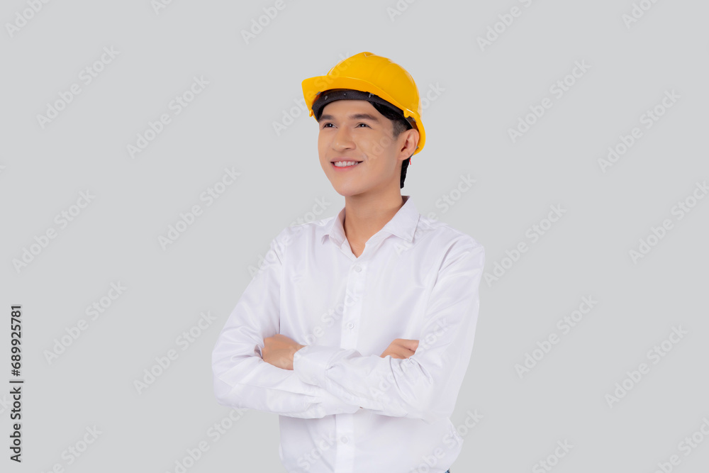 Portrait young asian man is engineer wearing helmet standing and smiling with confident isolated on white background, handsome male is architect or contractor, worker or labor, industrial concept. Portrait young asian man is engineer wearing helmet standing and smiling with confident isolated on white background, handsome male is architect or contractor, worker or labor, industrial concept.
