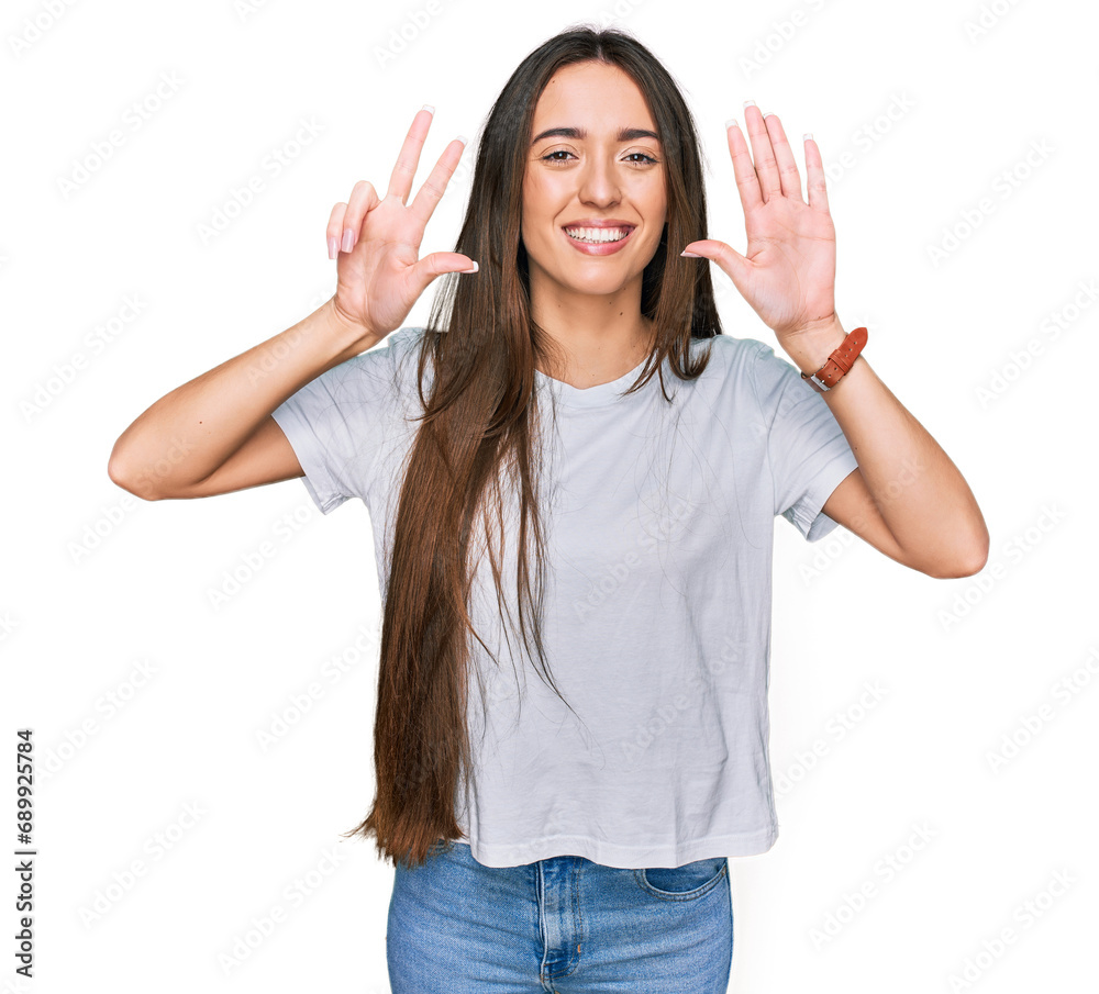 Young hispanic girl wearing casual white t shirt showing and pointing up with fingers number eight while smiling confident and happy. Young hispanic girl wearing casual white t shirt showing and pointing up with fingers number eight while smiling confident and happy.