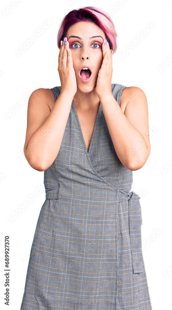Young beautiful woman with pink hair wearing casual clothes afraid and shocked, surprise and amazed expression with hands on face Young beautiful woman with pink hair wearing casual clothes afraid and shocked, surprise and amazed expression with hands on face