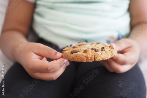 closeup of child mouth eating whole meal cookies 