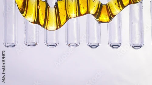  honey flows down glass tubes on a white background