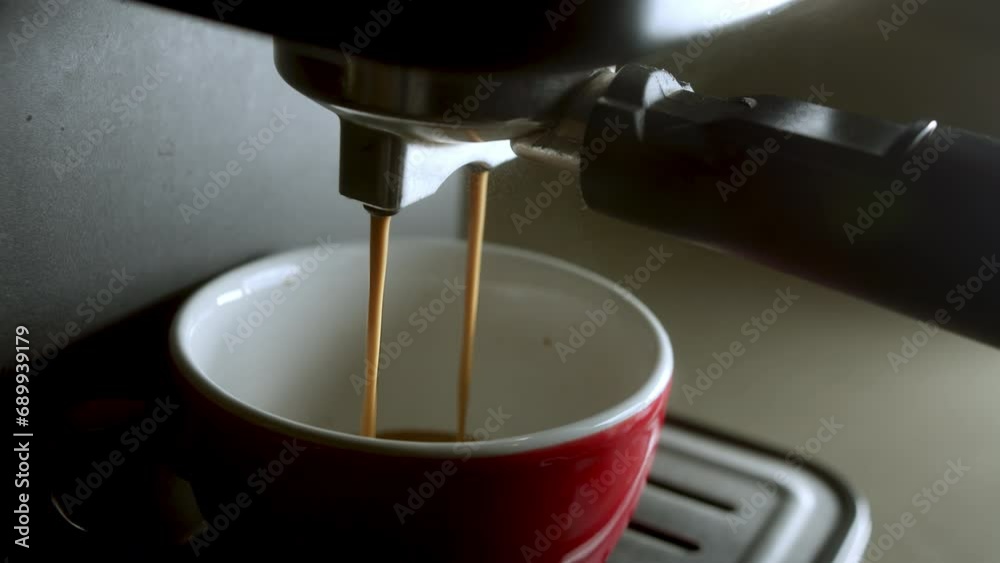 Home making hot espresso in the morning. Using filter holder. Flowing fresh ground coffee. Drinking roasted black coffee. Pouring coffee stream from machine in cup. 4K Home making hot espresso in the morning. Using filter holder. Flowing fresh ground coffee. Drinking roasted black coffee. Pouring coffee stream from machine in cup. 4K