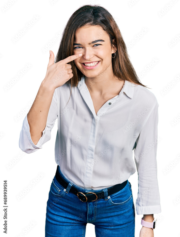 Young caucasian girl wearing casual white shirt pointing with hand finger to face and nose, smiling cheerful. beauty concept Young caucasian girl wearing casual white shirt pointing with hand finger to face and nose, smiling cheerful. beauty concept