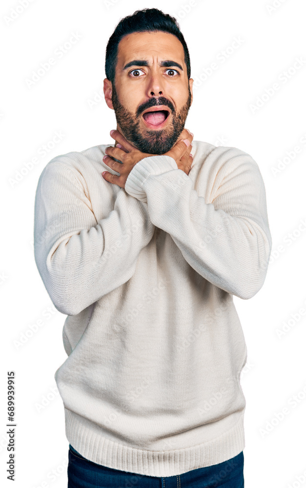 Young hispanic man with beard wearing casual white sweater shouting and suffocate because painful strangle. health problem. asphyxiate and suicide concept.