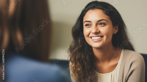 Beautiful young woman talking to her psychotherapist during therapy session