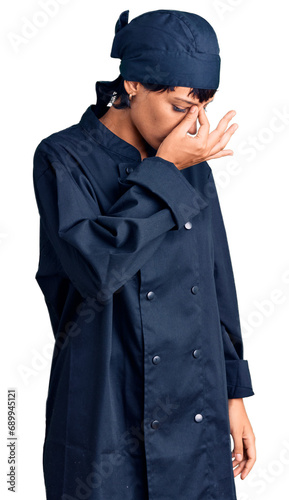 Young brunette woman with short hair wearing professional cook uniform tired rubbing nose and eyes feeling fatigue and headache. stress and frustration concept.
