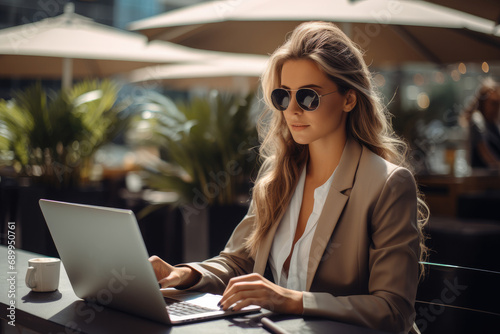 Businesswoman sitting with laptop at outdoor at outdoor cafe.