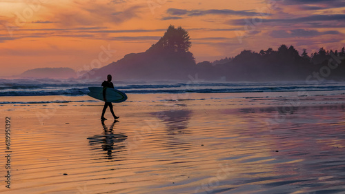 Tofino beach Vancouver Island Pacific rim coast during sunset, surfers with surfboard during sunset at the beach, surfers silhouette Canada Vancouver Island Tofino Long beach photo