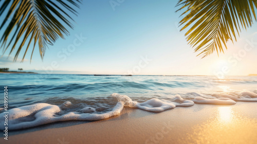 Beautiful tropical beach with palm leaf and sea wave at sunset time