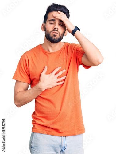 Young handsome man with beard wearing casual t-shirt touching forehead for illness and fever, flu and cold, virus sick