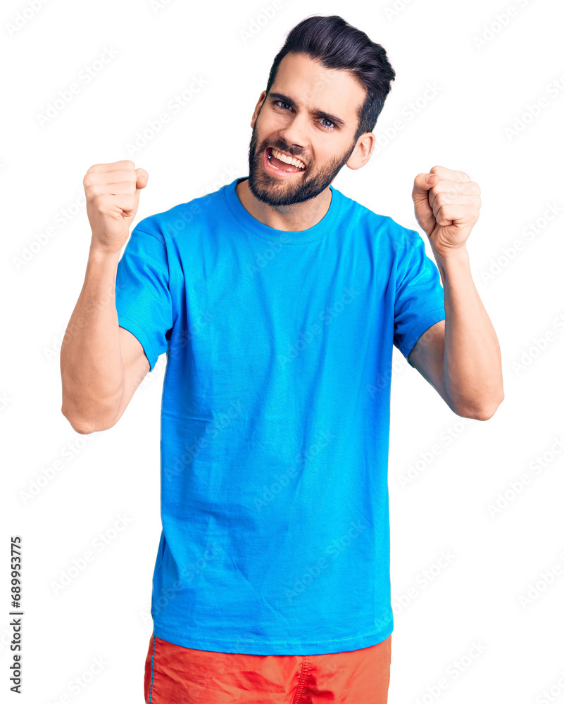 Young handsome man with beard wearing casual t-shirt screaming proud, celebrating victory and success very excited with raised arms Young handsome man with beard wearing casual t-shirt screaming proud, celebrating victory and success very excited with raised arms