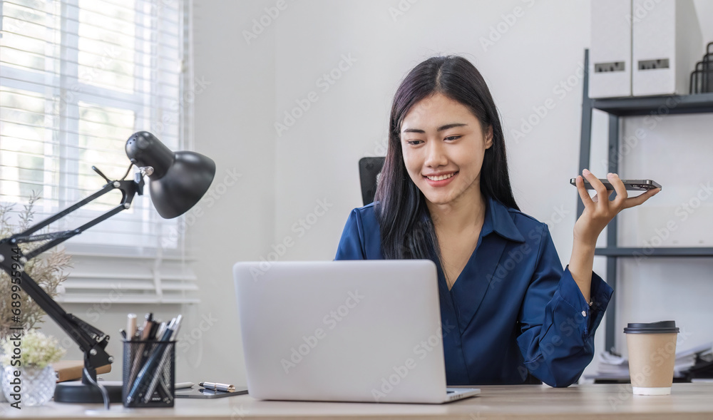 Young happy asian woman talking on mobile phone, relaxing while working at co-workspace. Young happy asian woman talking on mobile phone, relaxing while working at co-workspace.