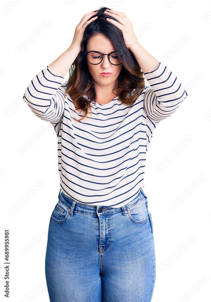 Beautiful young brunette woman wearing casual clothes and glasses suffering from headache desperate and stressed because pain and migraine. hands on head. Beautiful young brunette woman wearing casual clothes and glasses suffering from headache desperate and stressed because pain and migraine. hands on head.