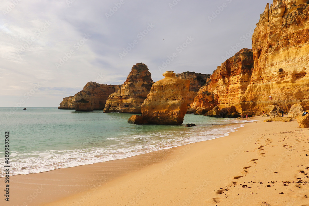Sandy beach with rocks in the water on a winter day in southern Portugal. Sandy beach with rocks in the water on a winter day in southern Portugal.