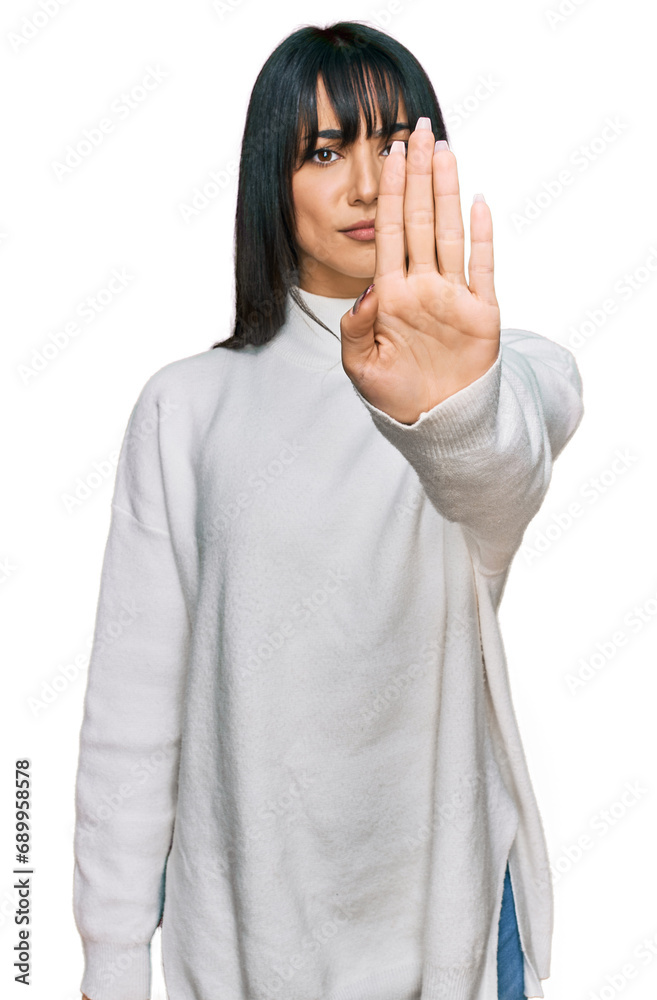 Young brunette woman with bangs wearing casual turtleneck sweater doing stop sing with palm of the hand. warning expression with negative and serious gesture on the face. Young brunette woman with bangs wearing casual turtleneck sweater doing stop sing with palm of the hand. warning expression with negative and serious gesture on the face.