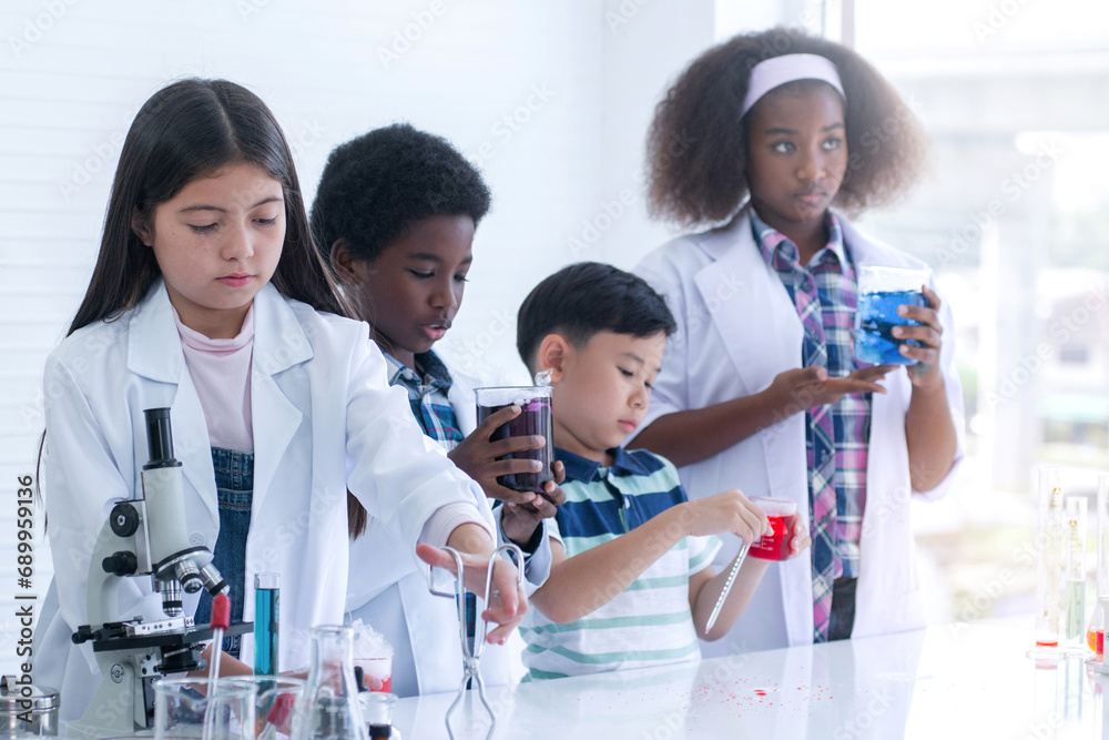 Group of students from different nationalities were paying attention to the test tubes in their hands, selective focus Group of students from different nationalities were paying attention to the test tubes in their hands, selective focus