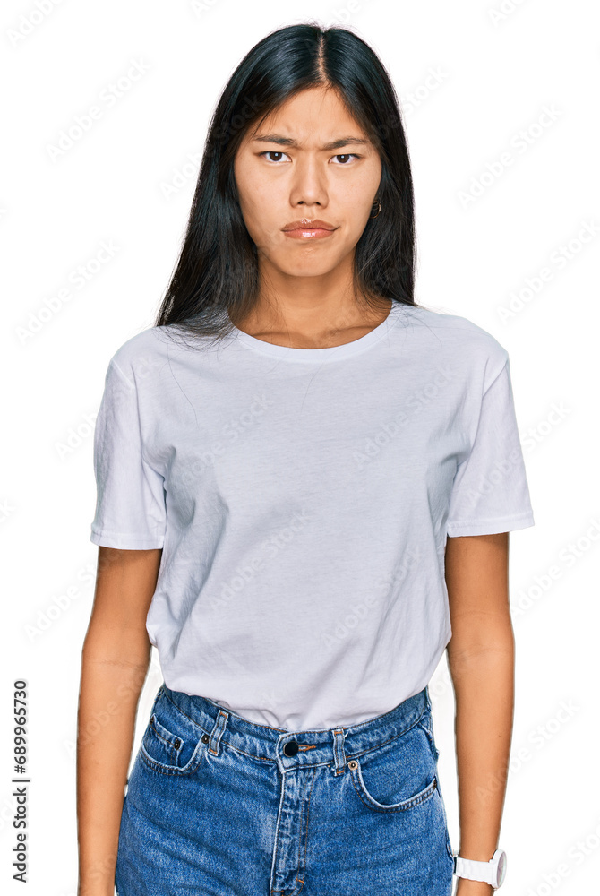 Beautiful young asian woman wearing casual white t shirt looking sleepy and tired, exhausted for fatigue and hangover, lazy eyes in the morning. Beautiful young asian woman wearing casual white t shirt looking sleepy and tired, exhausted for fatigue and hangover, lazy eyes in the morning.