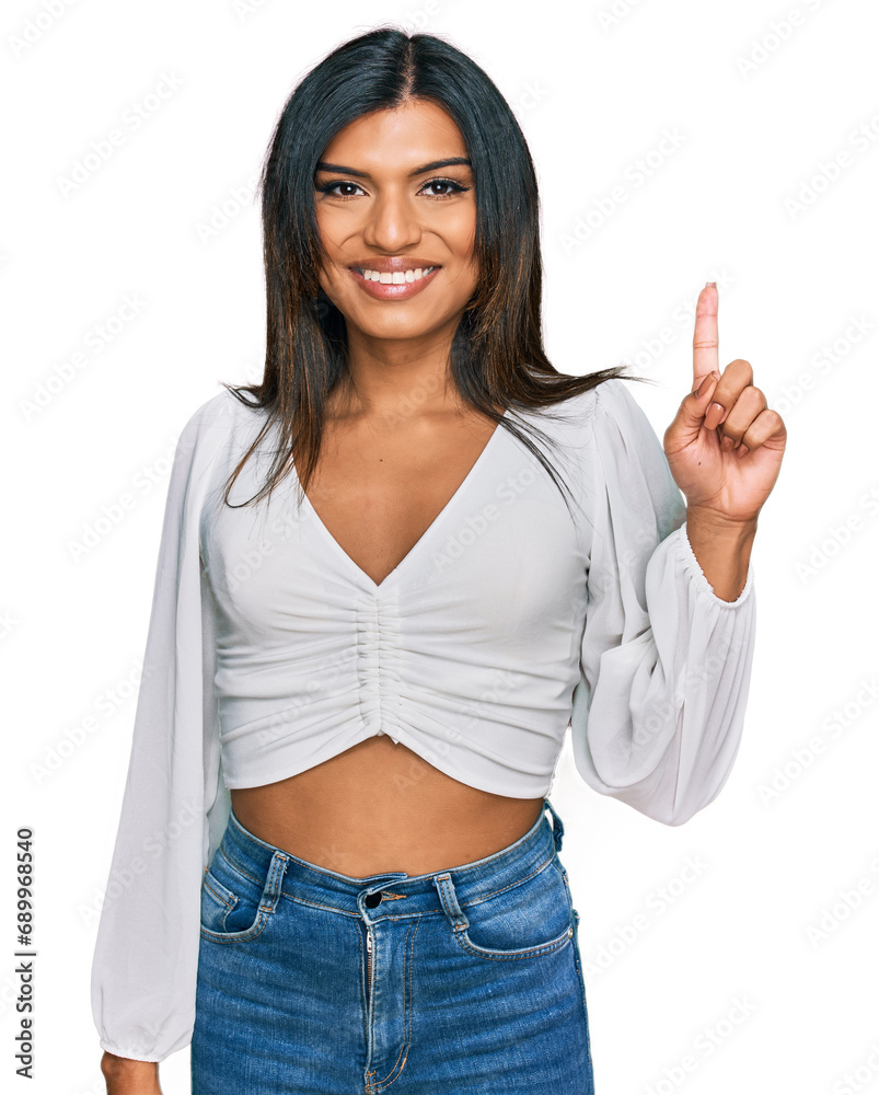 Young latin transsexual transgender woman wearing casual clothes showing and pointing up with finger number one while smiling confident and happy.