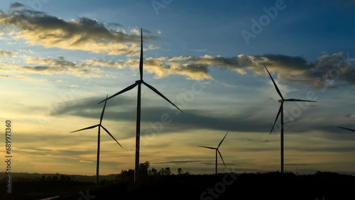 Wind turbines  on sunset background. Natural energy