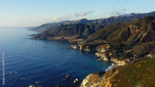 4k aerial drone footage of a Mountain Along Pacific Coast in Monterey. Big Sur national park, California road to San Francisco. Spectacular view on the blue ocean on the sunset