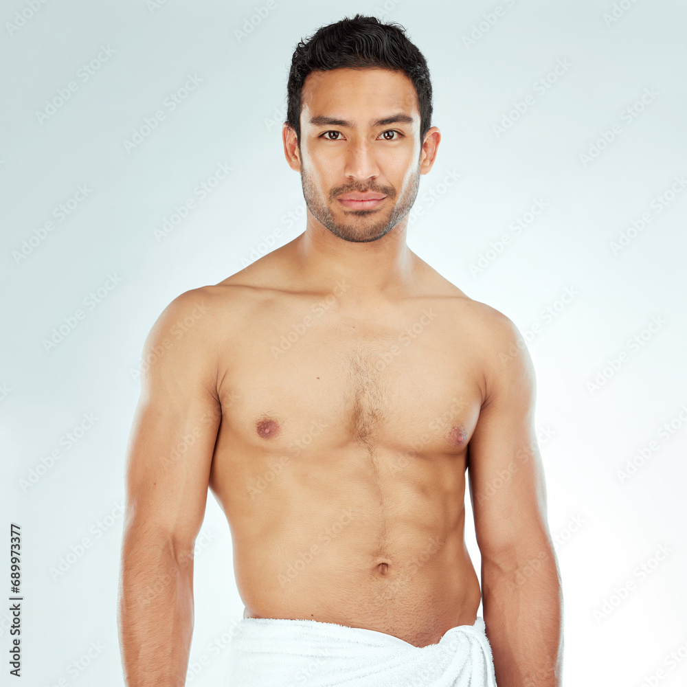 Body, chest and portrait of asian man in a towel in studio for cleaning, hygiene and care on white background. Face, confidence muscular Japanese model with glowing skin grooming results after shower