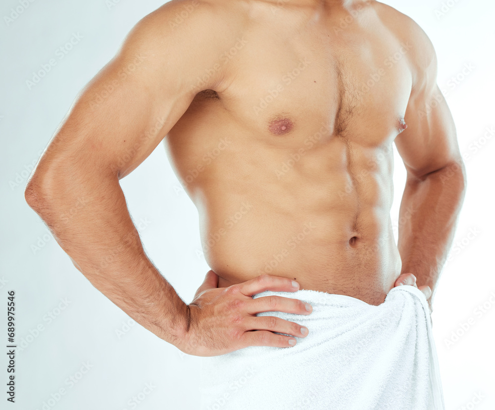 Fitness, body and closeup of man in a towel in studio for shower, wellness or grooming on white background. Chest, stomach and male model in a bathroom for cosmetic, care or cleaning with a sixpack