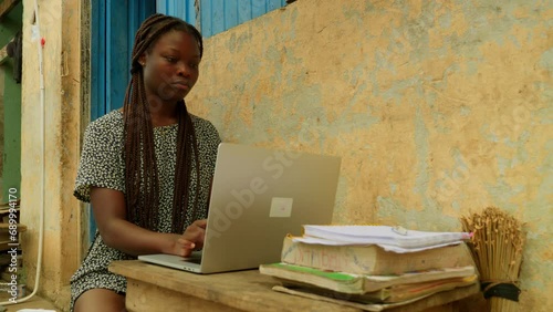 Using internet and technology to learn online, a young woman is getting access to education from her remote village in Kumasi, Ghana in Africa. photo