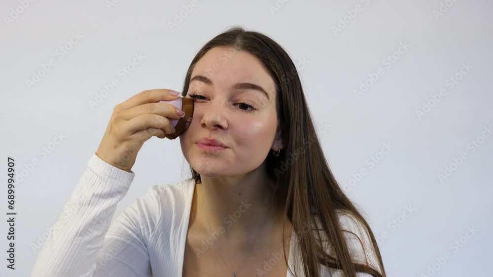 Stunning young Caucasian female brunette applying makeup in the morning preparation Stunning young Caucasian female brunette applying makeup in the morning preparation