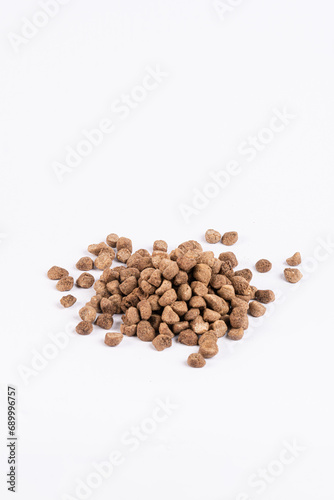 Dry dog food pellets on a white isolated background
