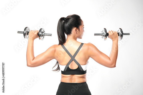 an asian woman is working out with dumbbells wearing the sport exercise suit with white background,