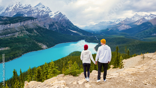 Lake Peyto Banff National Park Canada. Mountain Lake as Fox Head is popular among tourists in Canada driving the Icefields parkway. couple of men and women looking out over the turqouse colored lake photo