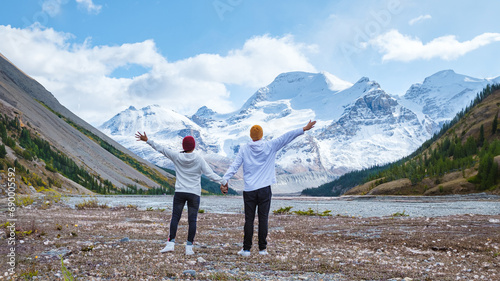 Icefields Parkway with autumn trees and snowy foggy mountains in Jasper Canada Alberta. couple of men and women on a road trip at Icefield Parkway Canadian Rockies  photo