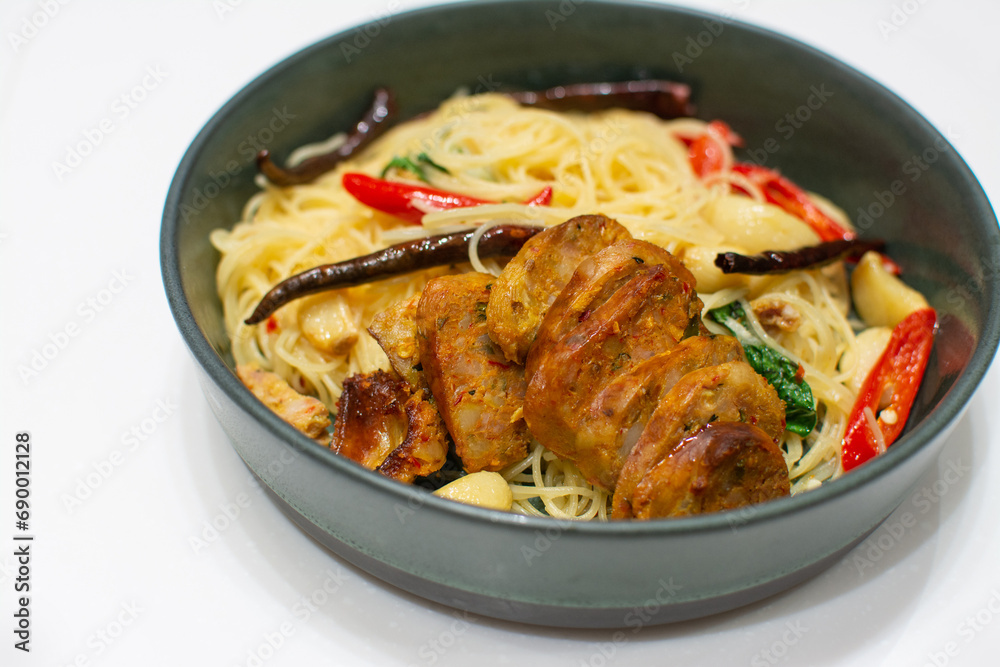 Spaghetti with Northern Thai spicy sausage on white background.