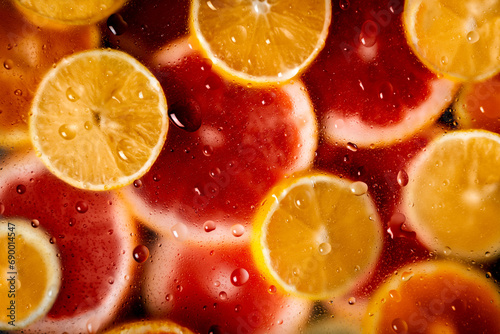 colorful background, cut grapefruit with water drops, flat lay © Ксения Маслова