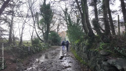 hillwalkers in ireland on an ancient trail to The Comeragh Mountains Waterford on a cold wet winter day photo