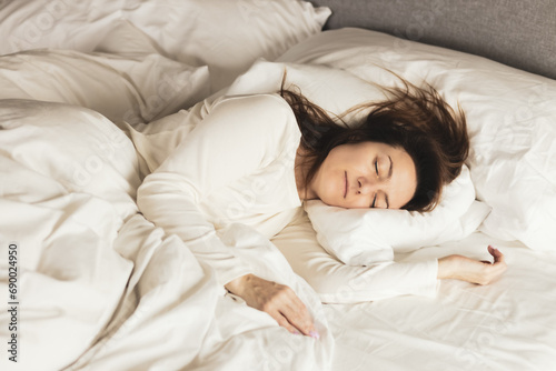 Portrait of young woman sleeping in the bed